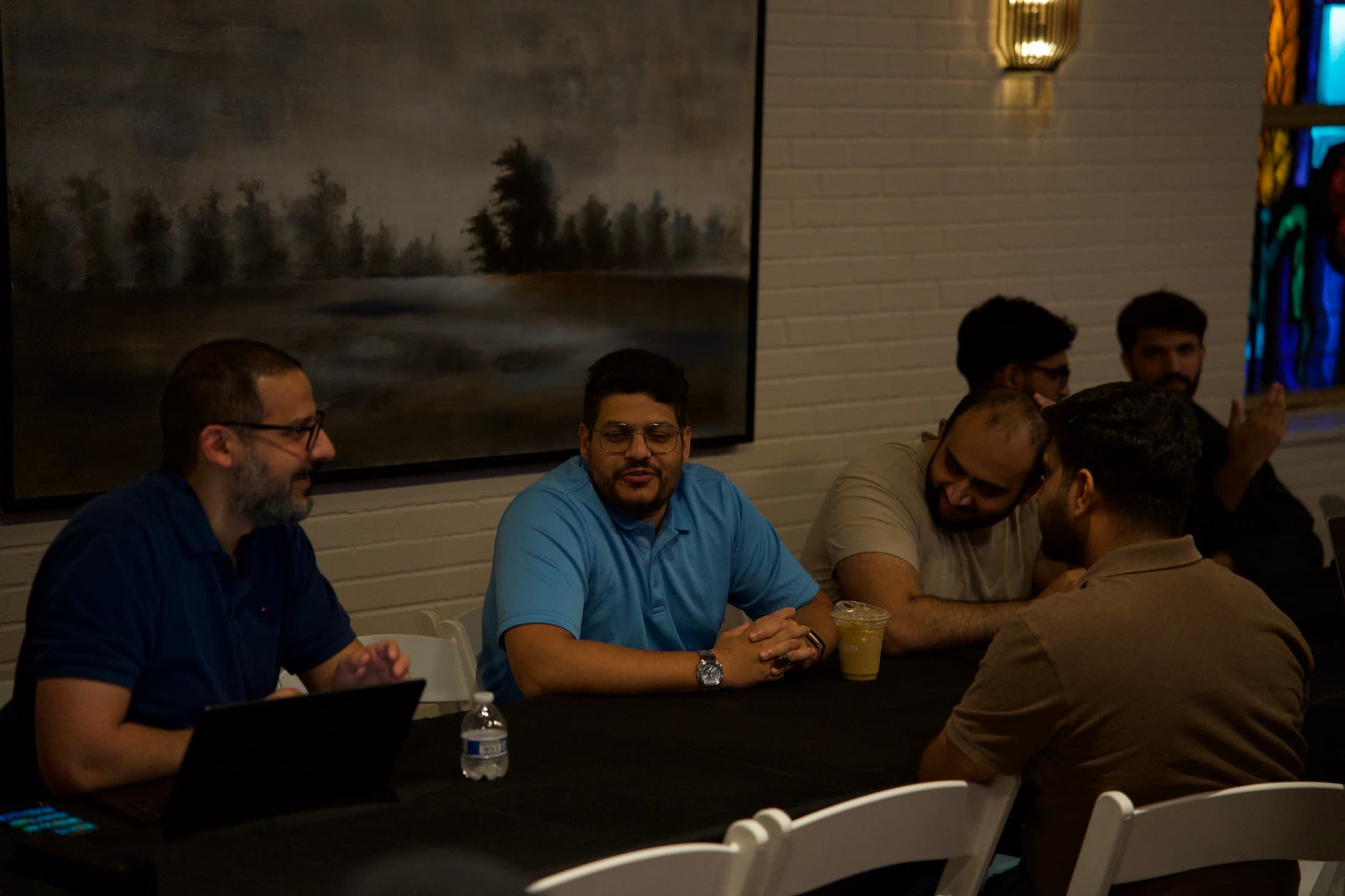 Four founders laughing at the end of a table
